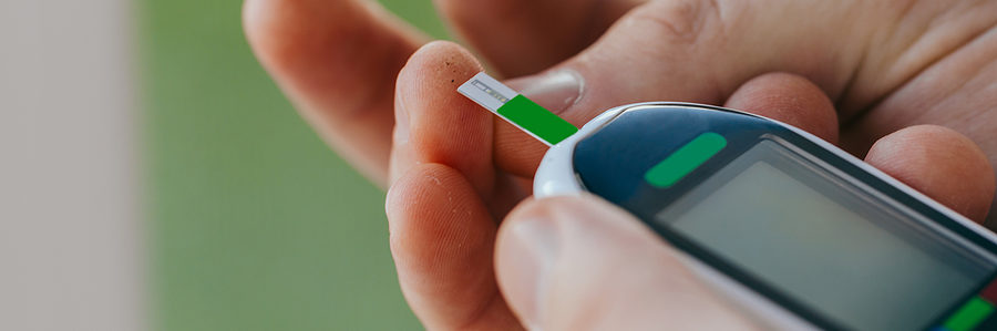 a person using a blood glucose meter
