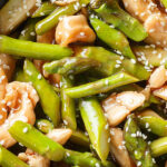 a bowl of Chicken With Asparagus & with chopsticks