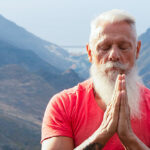 Senior man meditating to lower stress