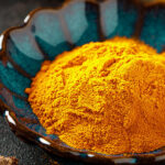 Indian turmeric powder and root. Turmeric spice