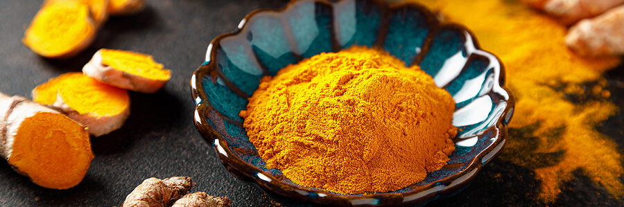 Indian turmeric powder and root. Turmeric spice
