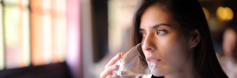 woman drinking water for lower blood pressure