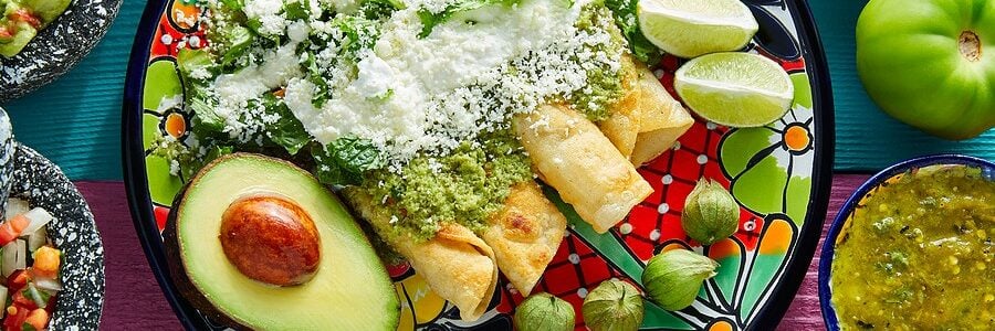 A heart-healthy dish of enchiladas topped with green sauce and cheese