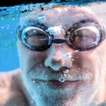 a person in goggles and swimming goggles in a pool